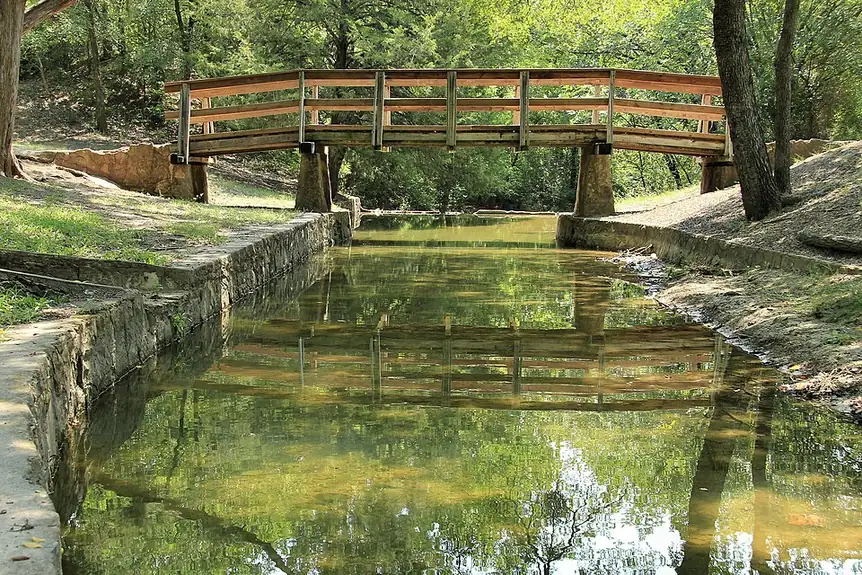 A footbridge over the stone channel at Grapevine Springs Park in Coppell