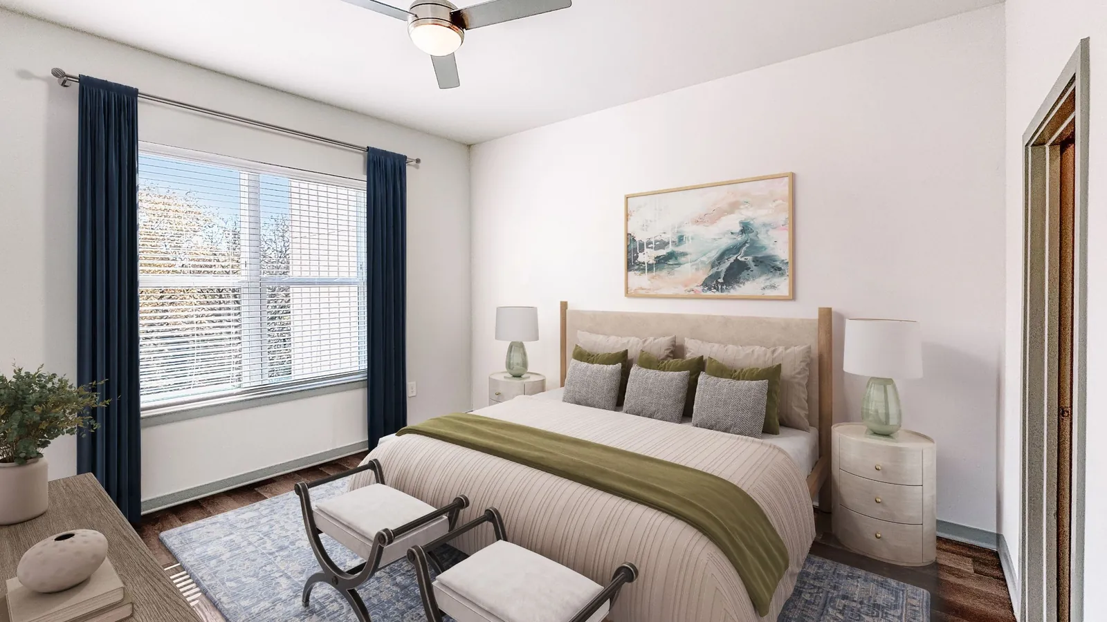 Jefferson Ederville in Fort Worth: bedroom with wood-look floors, an upholstered bed with a bench at its foot, a ceiling fan and navy curtains